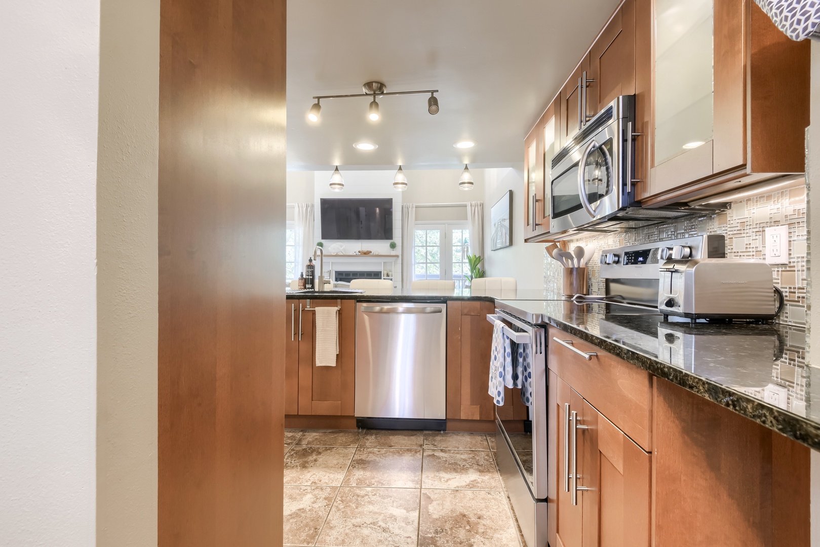 Ample cabinet and counter space with the living room just beyond