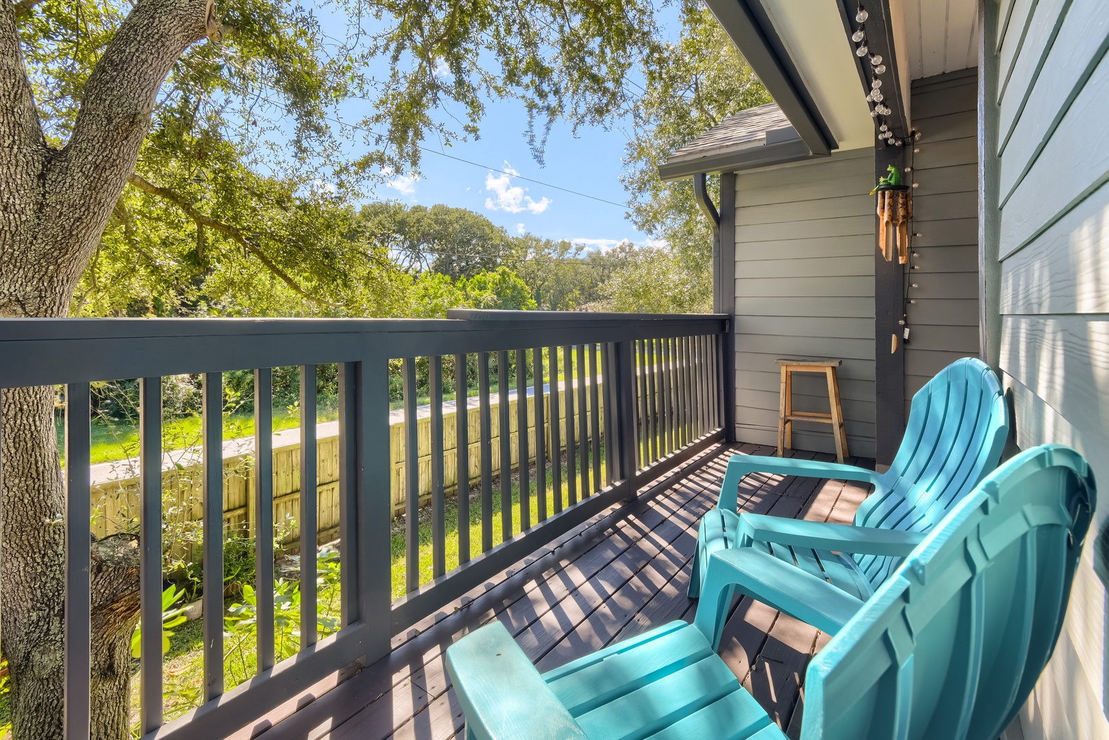 Relax on the deck with Adirondack chairs under the shade of mature oaks