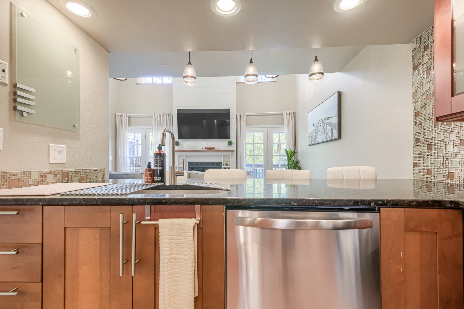Open kitchen sightlines let the cook stay part of the living room fun