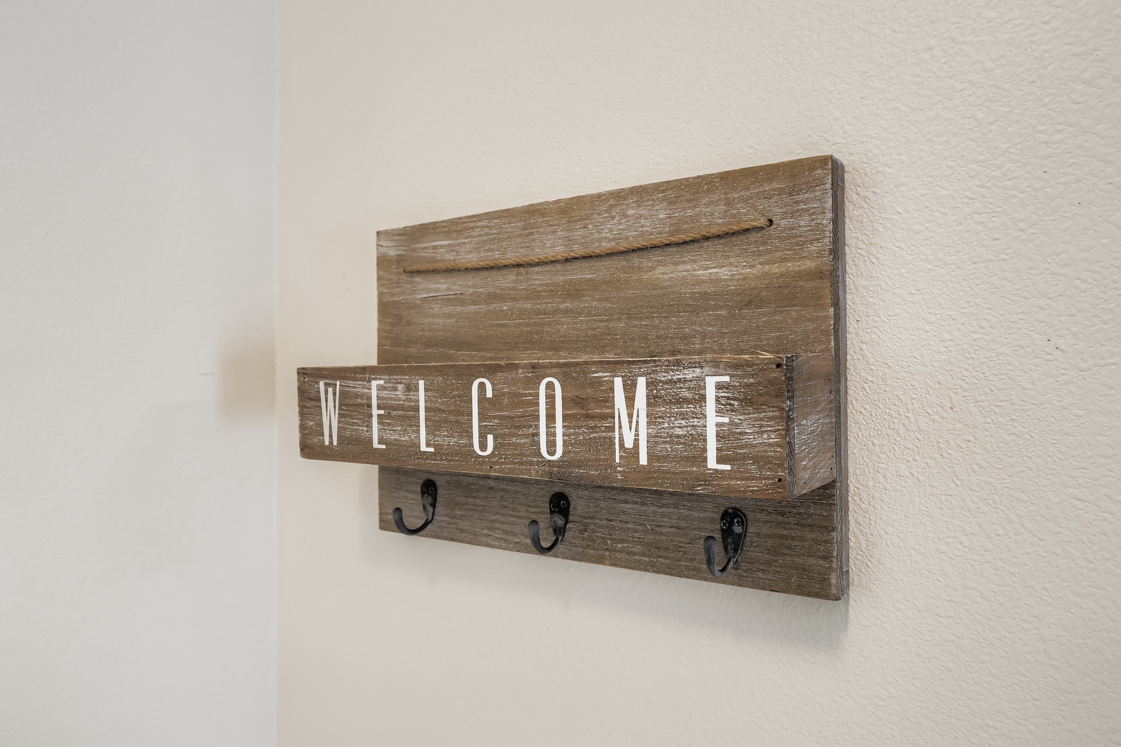 welcome sign with hooks.