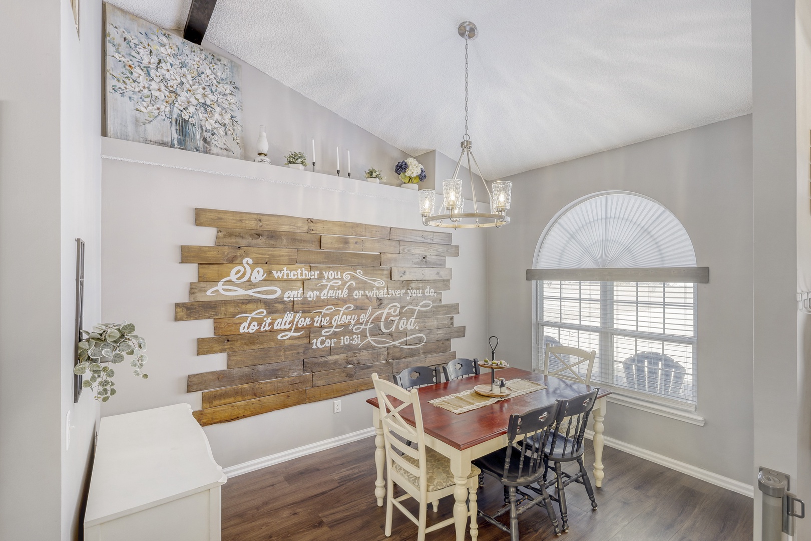Rustic dining table beneath sparkling chandeliers.