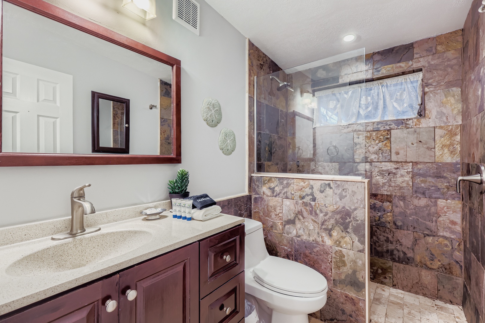 Beachy bathroom, stone shower retreat.