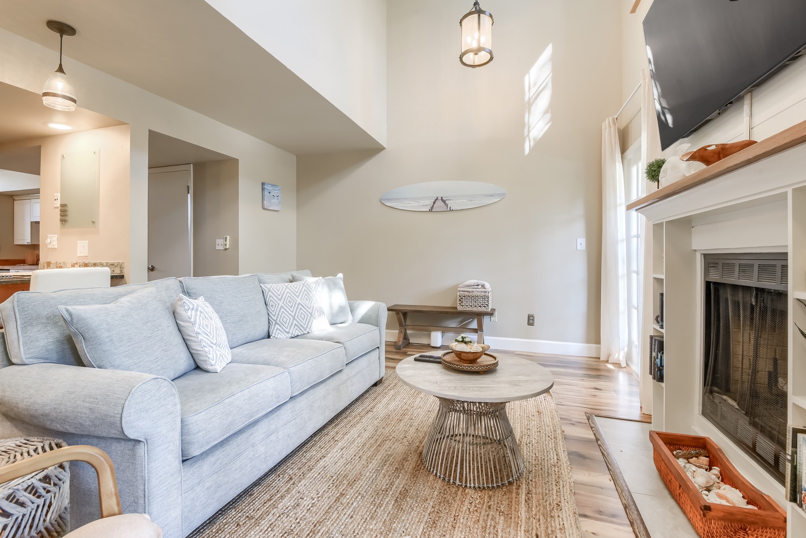 Soaring ceilings, natural light and coastal decor in the main living area