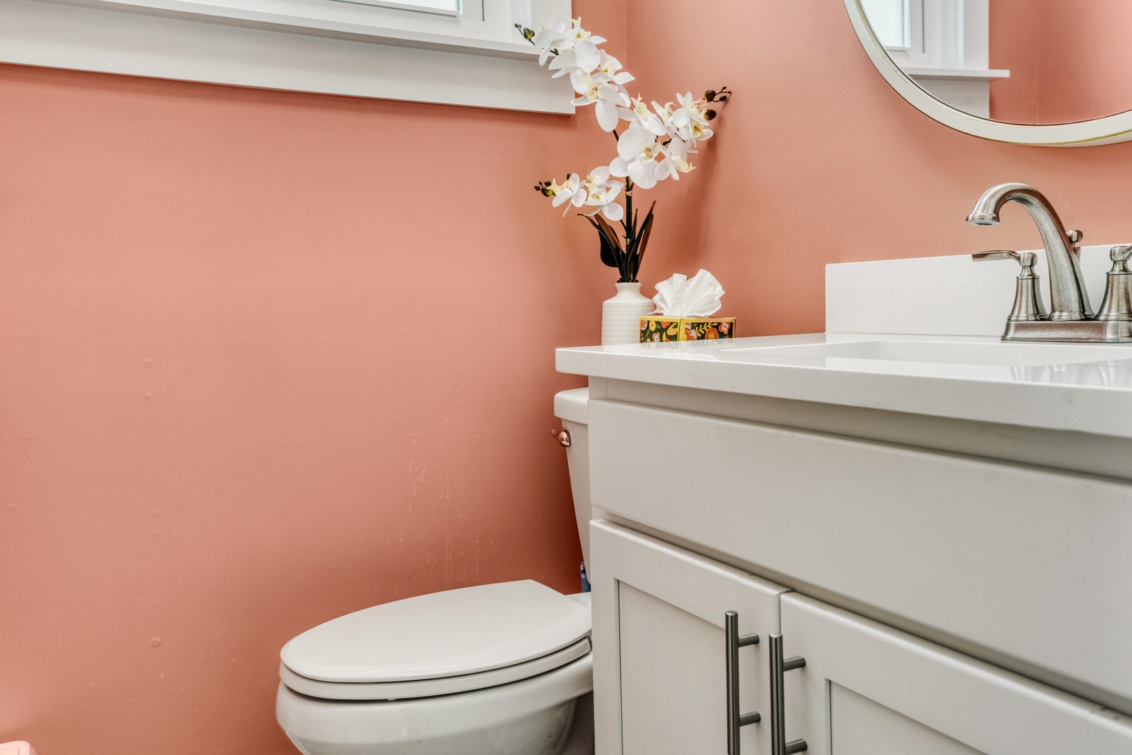Charming Coral Powder Room with Elegant Fixtures