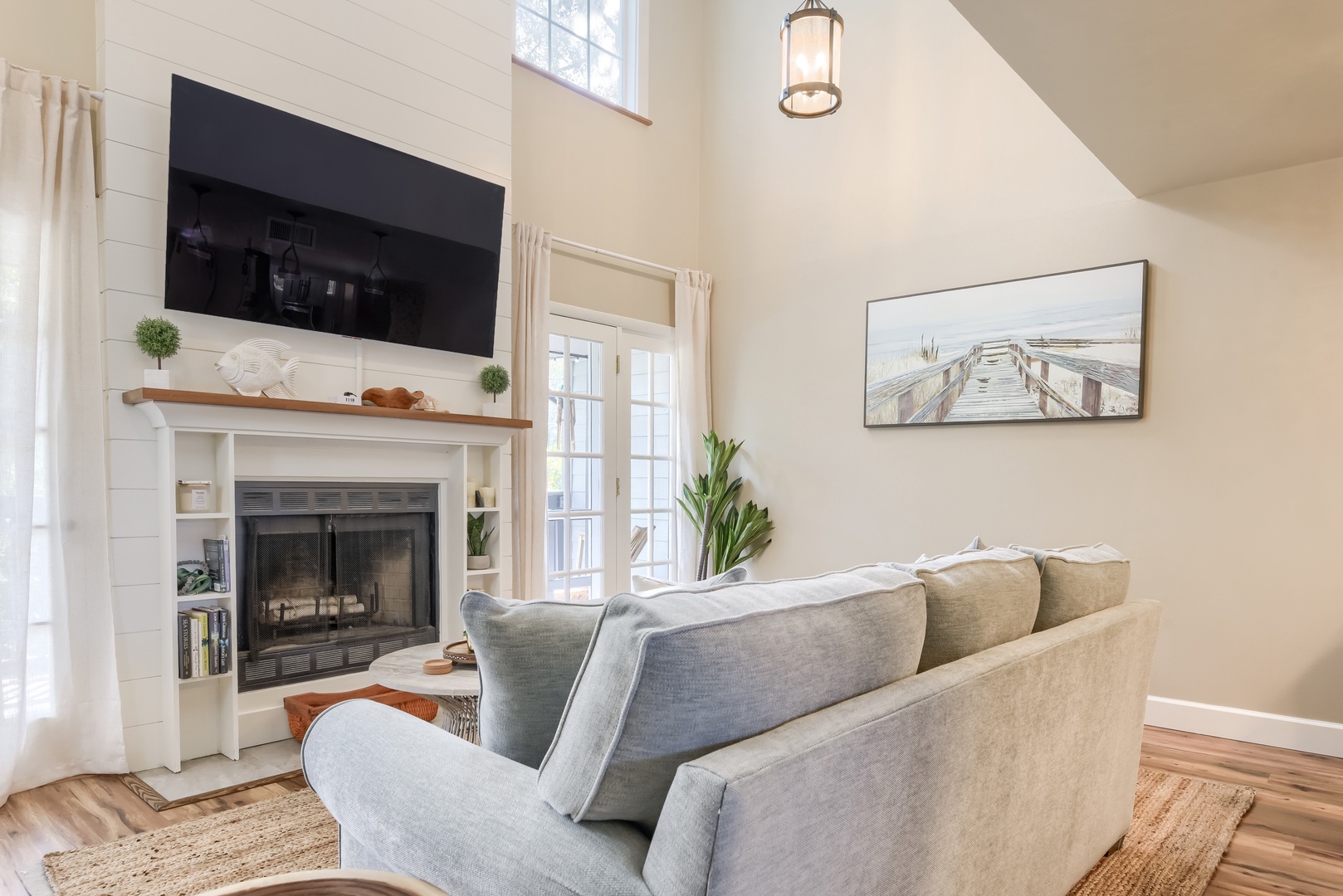 Gather around the fireplace and big-screen TV after a day at the beach