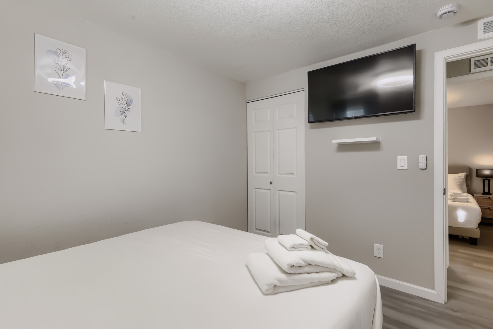 Primary bedroom smart TV and closet storage