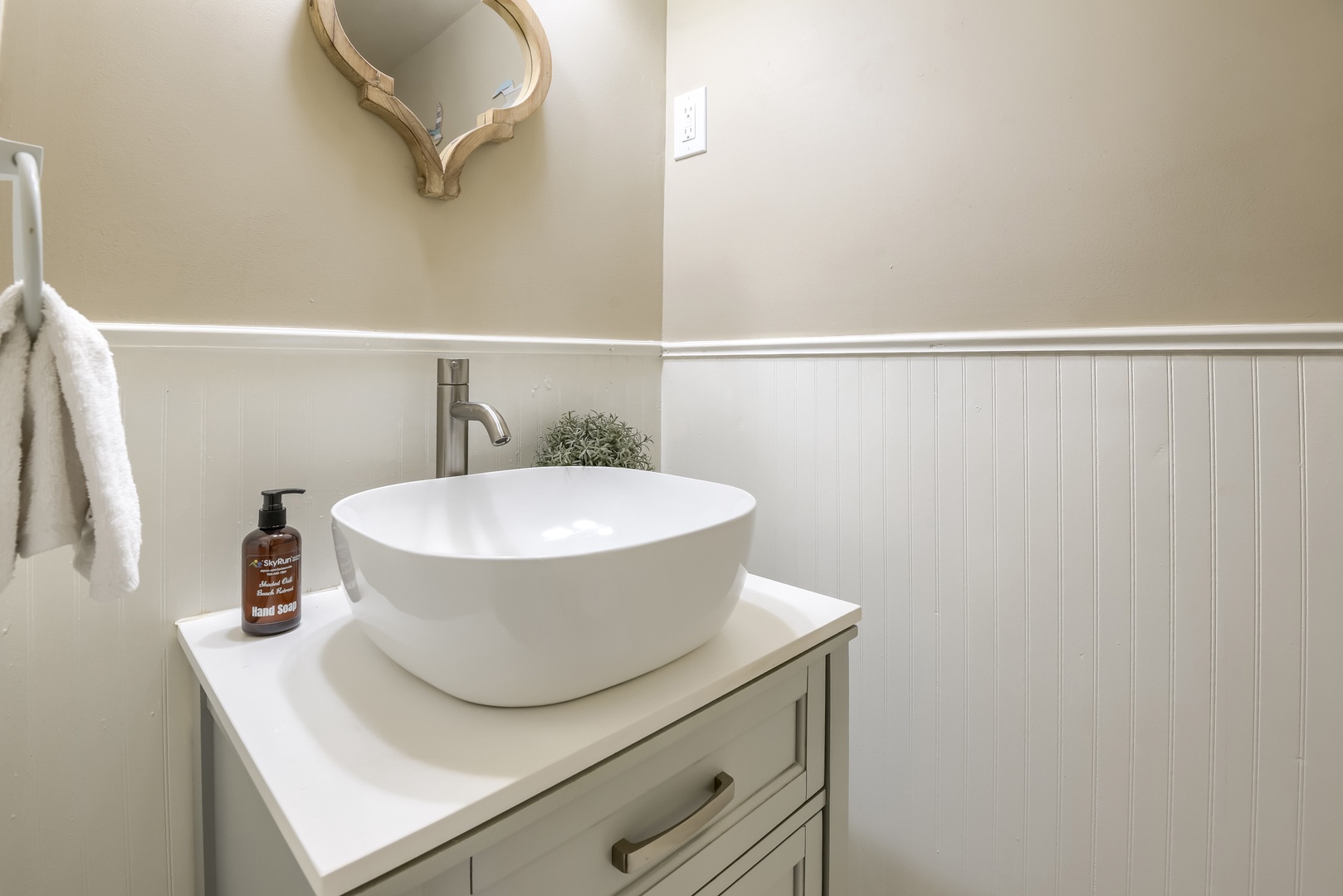 Downstairs half bath with vessel sink and beadboard walls