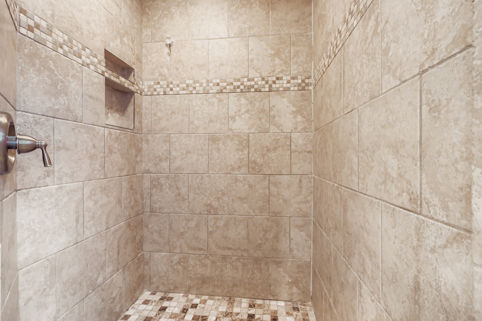 Spacious walk-in shower with elegant tile