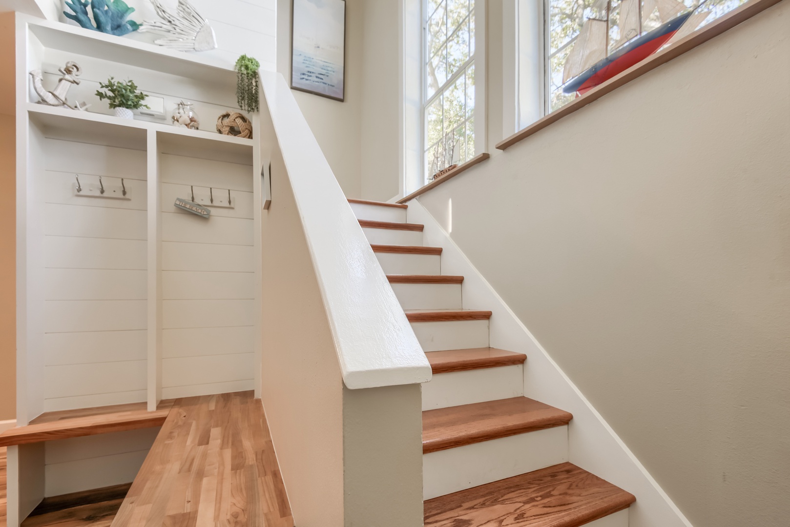 Bright staircase with wood treads leads to the upstairs bedrooms
