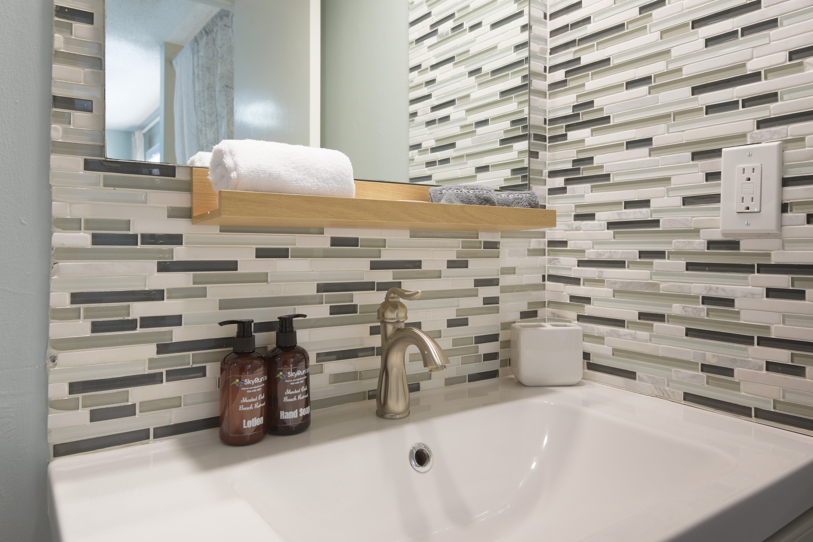 Glass mosaic tile vanity with soap and lotion ready for your stay