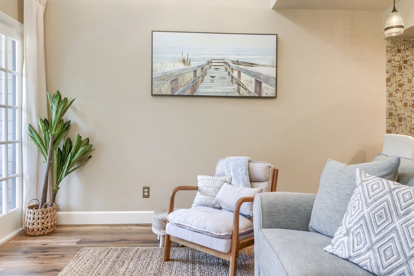 Quiet reading nook with a cushioned armchair and boardwalk artwork