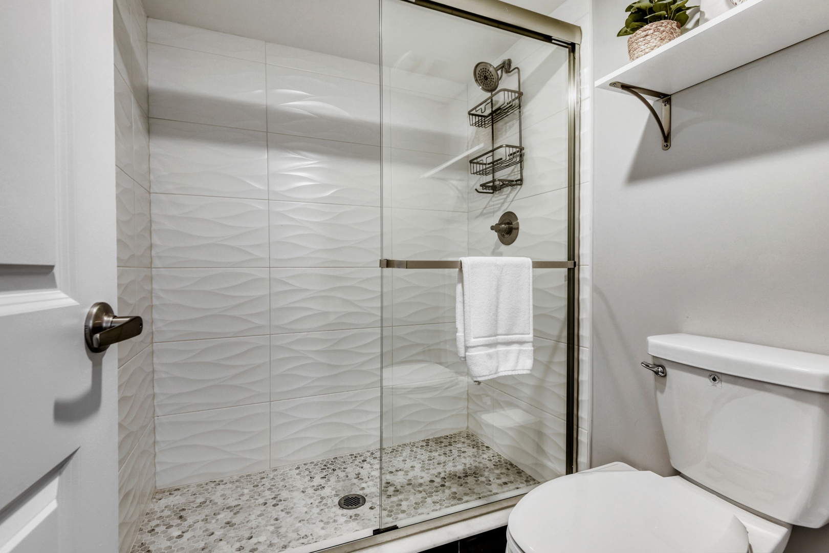 Spacious Walk-In Shower with Textured Tiles
