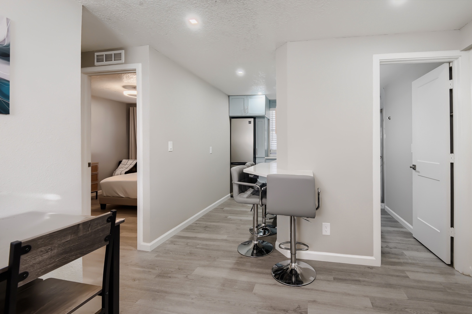 Hallway to the bedrooms, bathroom, and kitchen breakfast bar