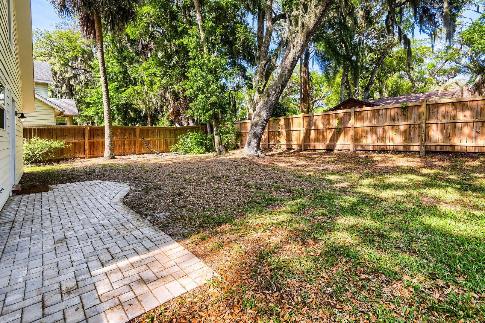 Your private backyard retreat features mature trees.