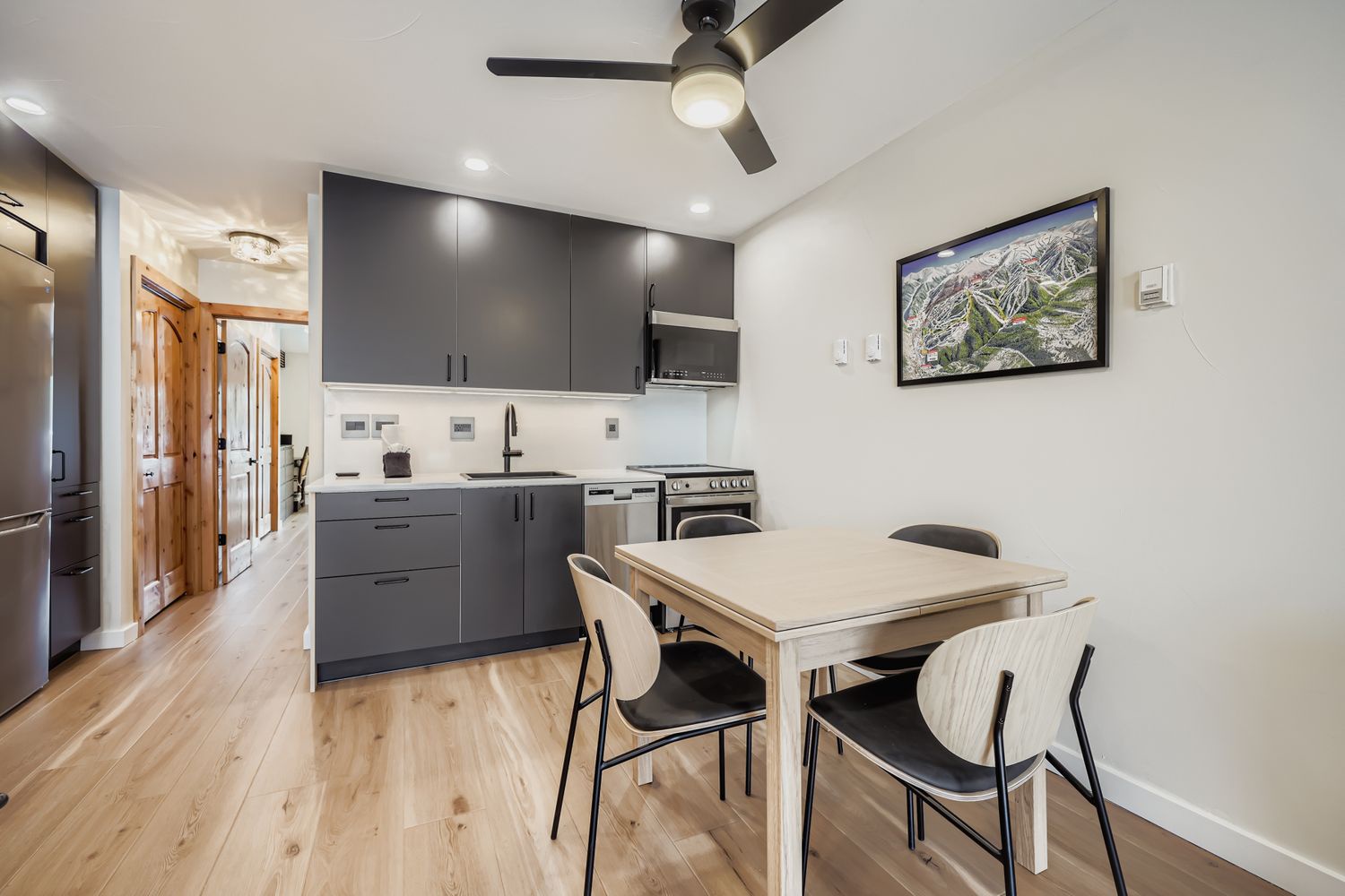 Your modern kitchen and dining area features sleek cabinets, stainless steel appliances, and a comfortable dining table where you can enjoy meals together.