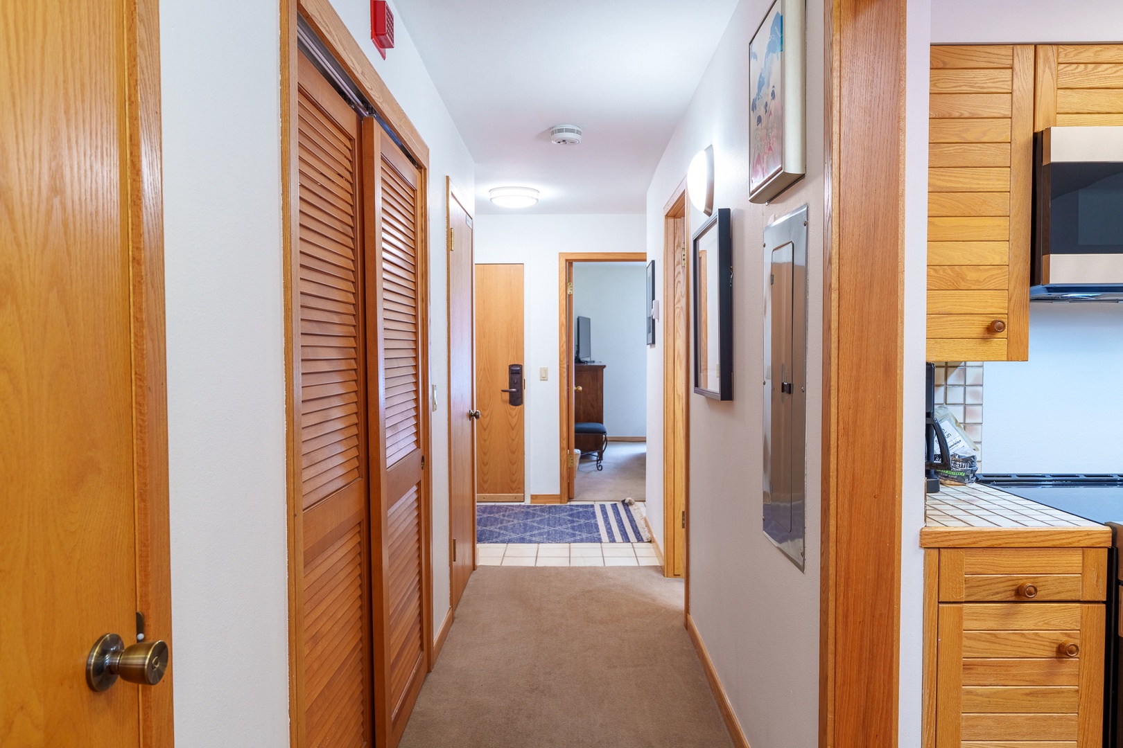 Step into your well-organized hallway with beautiful wood accents, leading to comfortable living spaces beyond.