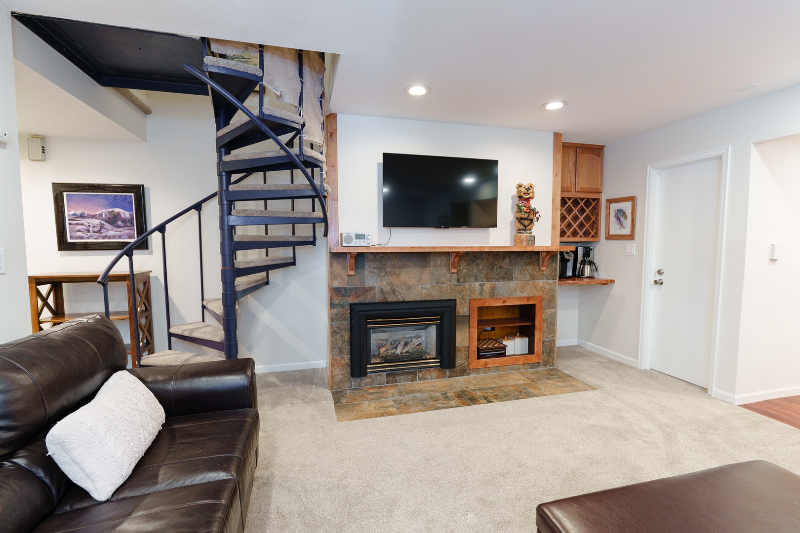 Relax in your spacious living area with plush leather seating, cozy fireplace, and modern entertainment center - perfect for unwinding after your mountain adventures.