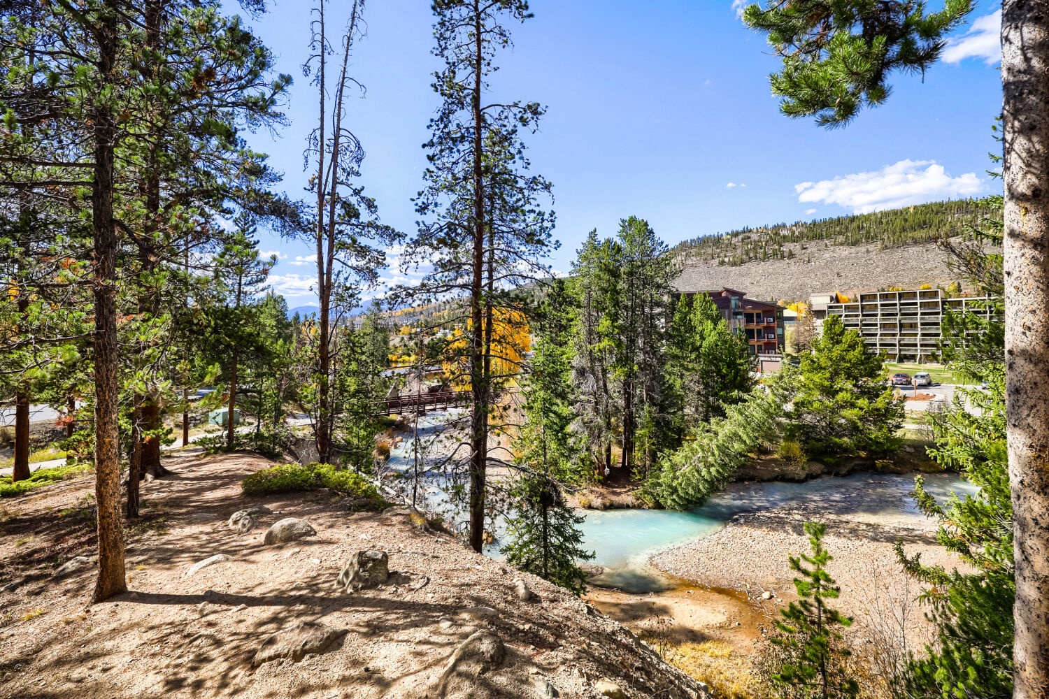 The property sits along a tranquil river bend, framed by towering pines and mountain slopes that set the stage for your alpine retreat.