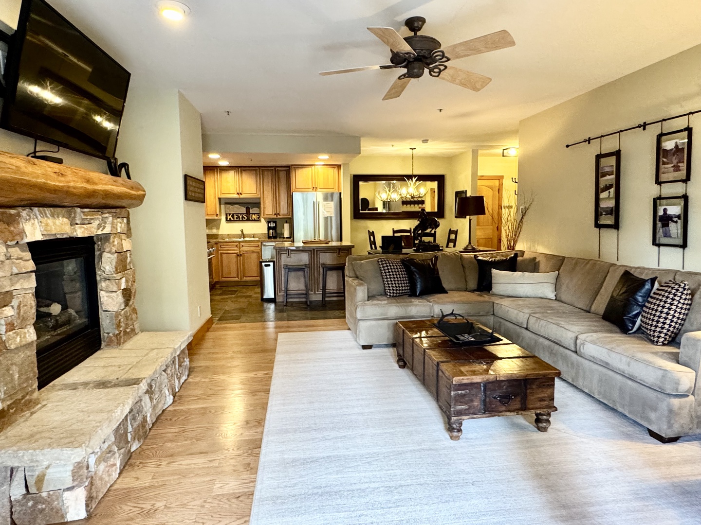 Unwind in your spacious living area, where a cozy stone fireplace and plush sectional invite you to relax after a day of adventure. The open layout flows into a fully-equipped kitchen, perfect for gathering with loved ones.
