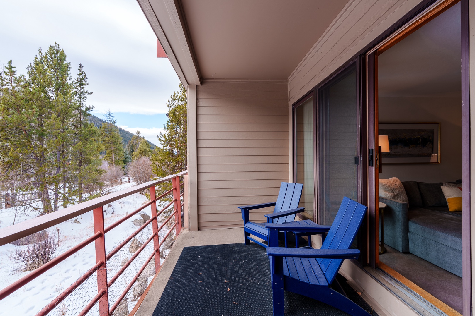Step onto your private balcony and breathe in the crisp mountain air while enjoying stunning winter views from your cozy chairs.