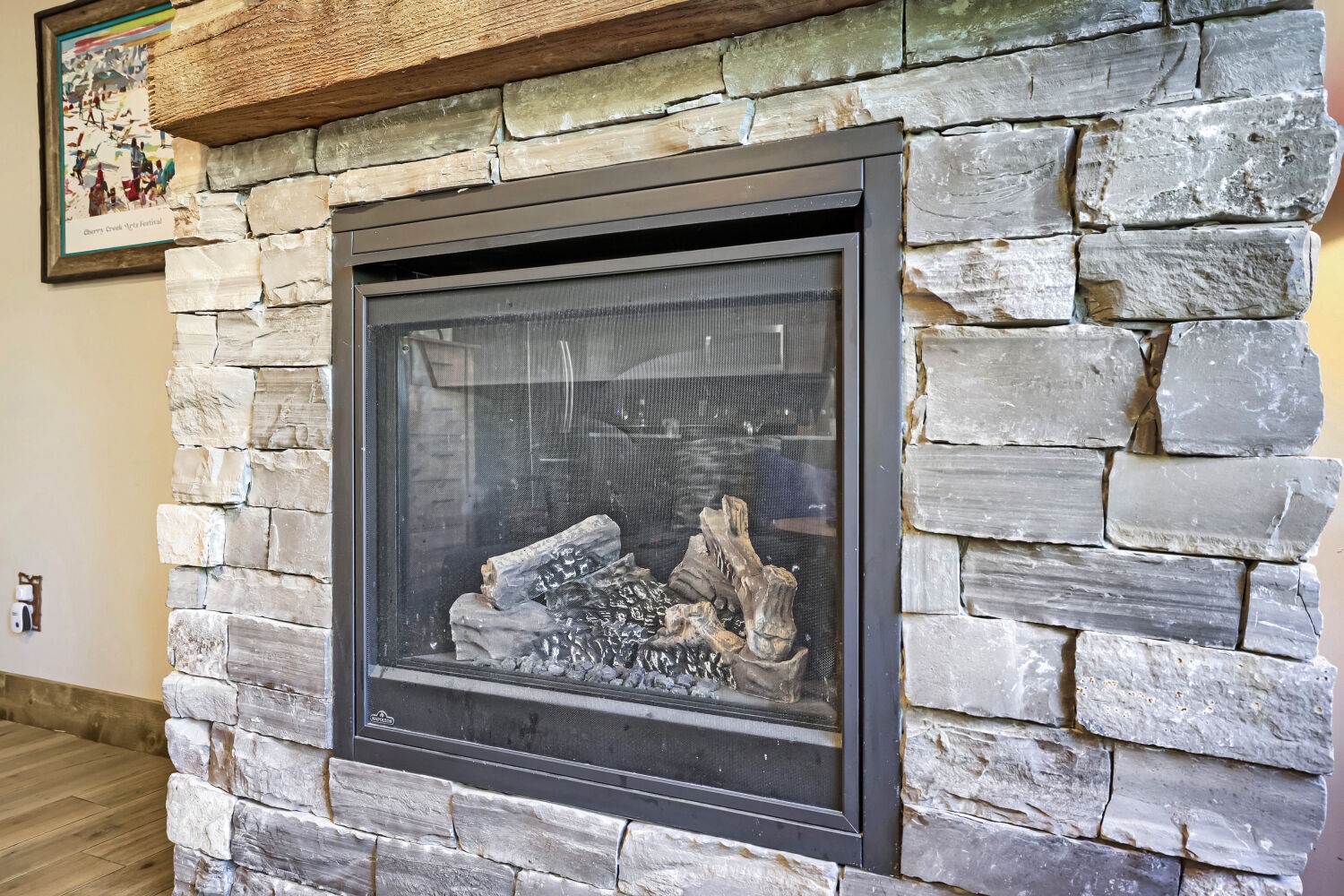 Gather around your private stone fireplace for cozy evenings in, complete with a rustic wood mantel and warm ambiance.