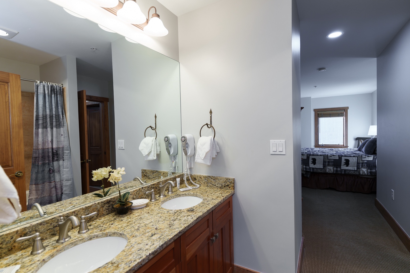 Your elegant bathroom features granite countertops, double sinks, and quality amenities for your comfort and convenience.
