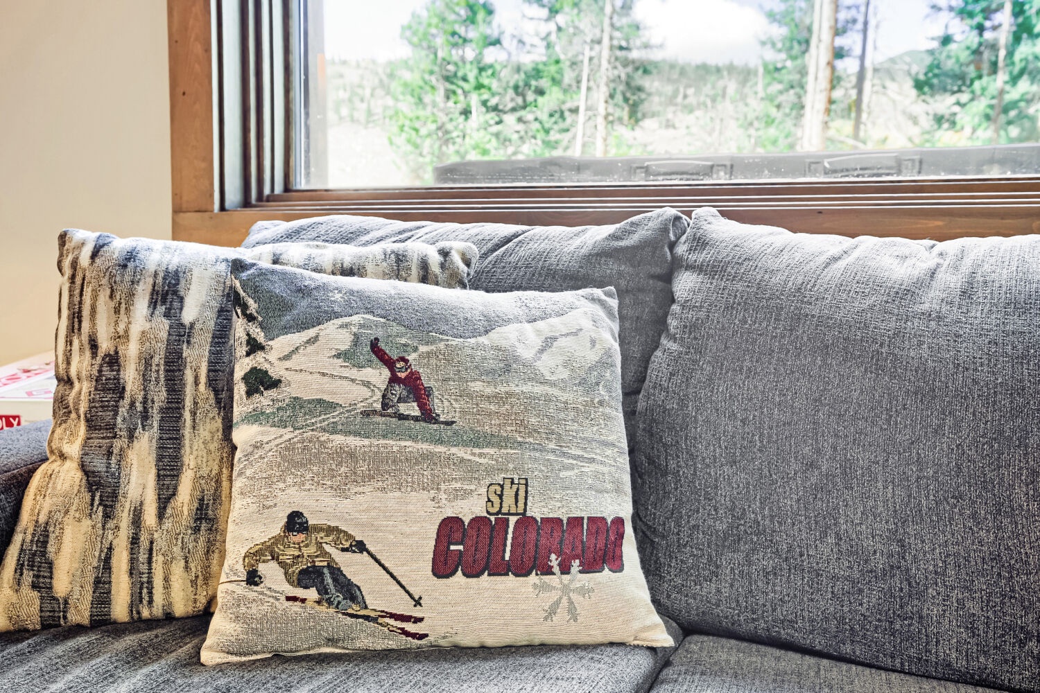 Curl up on the cozy sofa with soft throws and pillows, taking in the peaceful forest view through the window—a perfect spot to unwind after your day.
