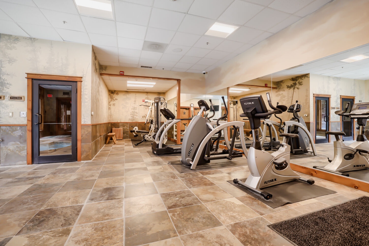 Stay active during your visit with cardio equipment including ellipticals and bikes in this well-lit fitness space.