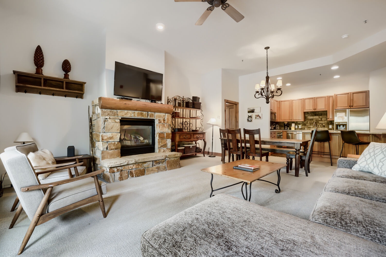Gather around the stunning stone fireplace in your open-concept living space, where rustic elegance meets modern comfort. Vaulted ceilings and thoughtful design create the perfect retreat for relaxing evenings.