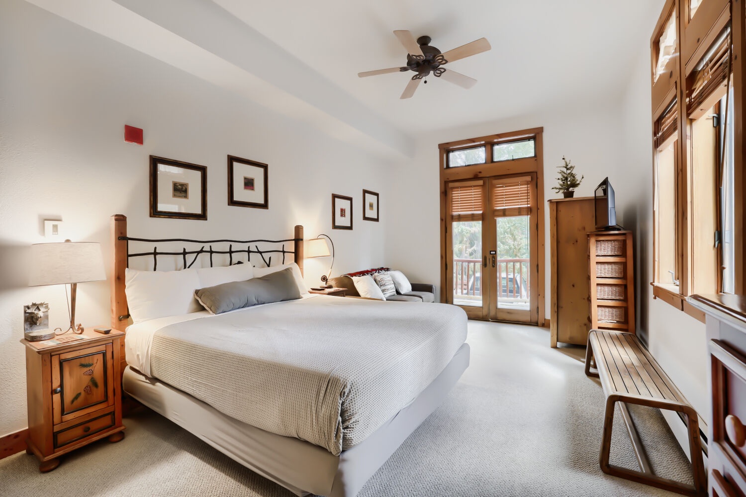 Drift off in your serene bedroom where crisp white linens and warm wood accents create a peaceful mountain retreat. Natural light pours through your private balcony doors, inviting you to step outside and breathe in the fresh air.