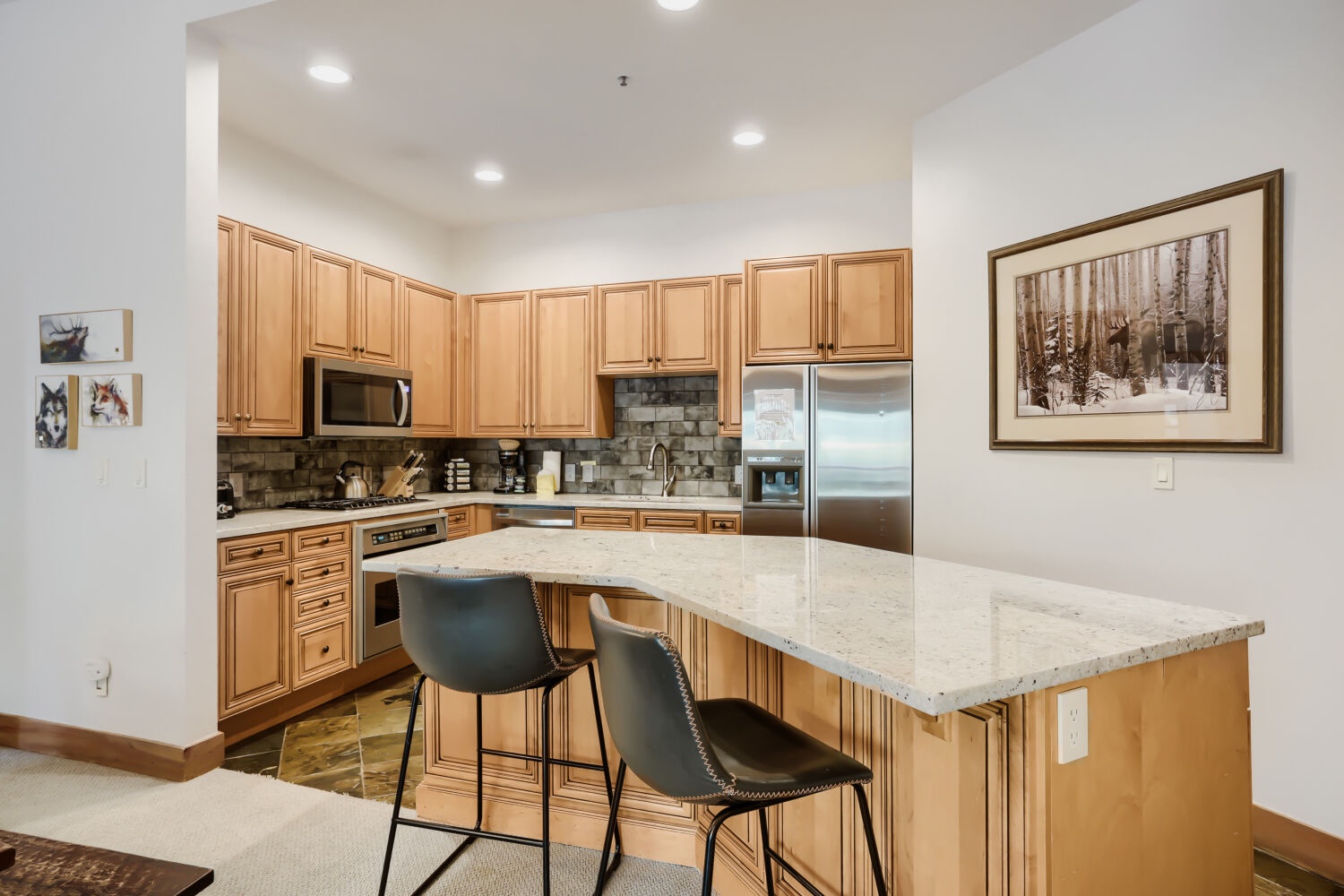 Your fully equipped kitchen features warm wood cabinetry, granite countertops, and stainless steel appliances. Pull up to the island for a casual meal or prep your favorite dishes—everything you need is right here.