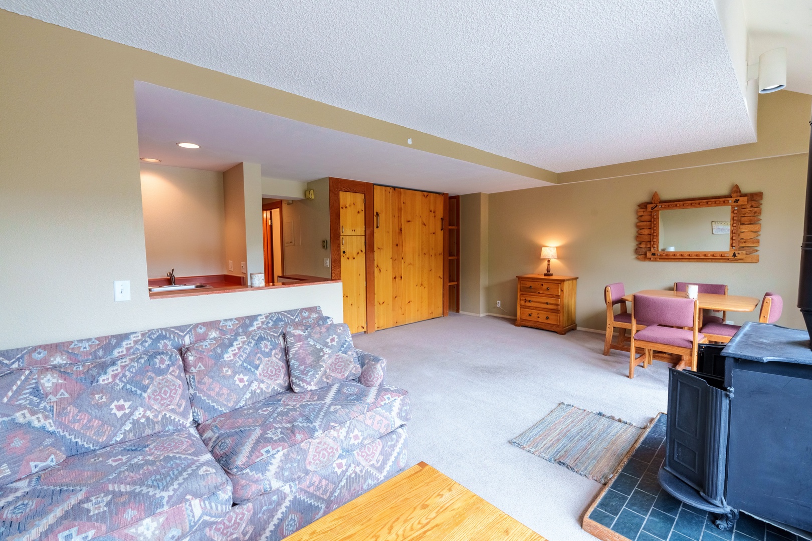 Settle into your spacious living area featuring plush seating, warm wood accents, and an open layout that flows seamlessly to your kitchen—perfect for unwinding after a day of adventure.