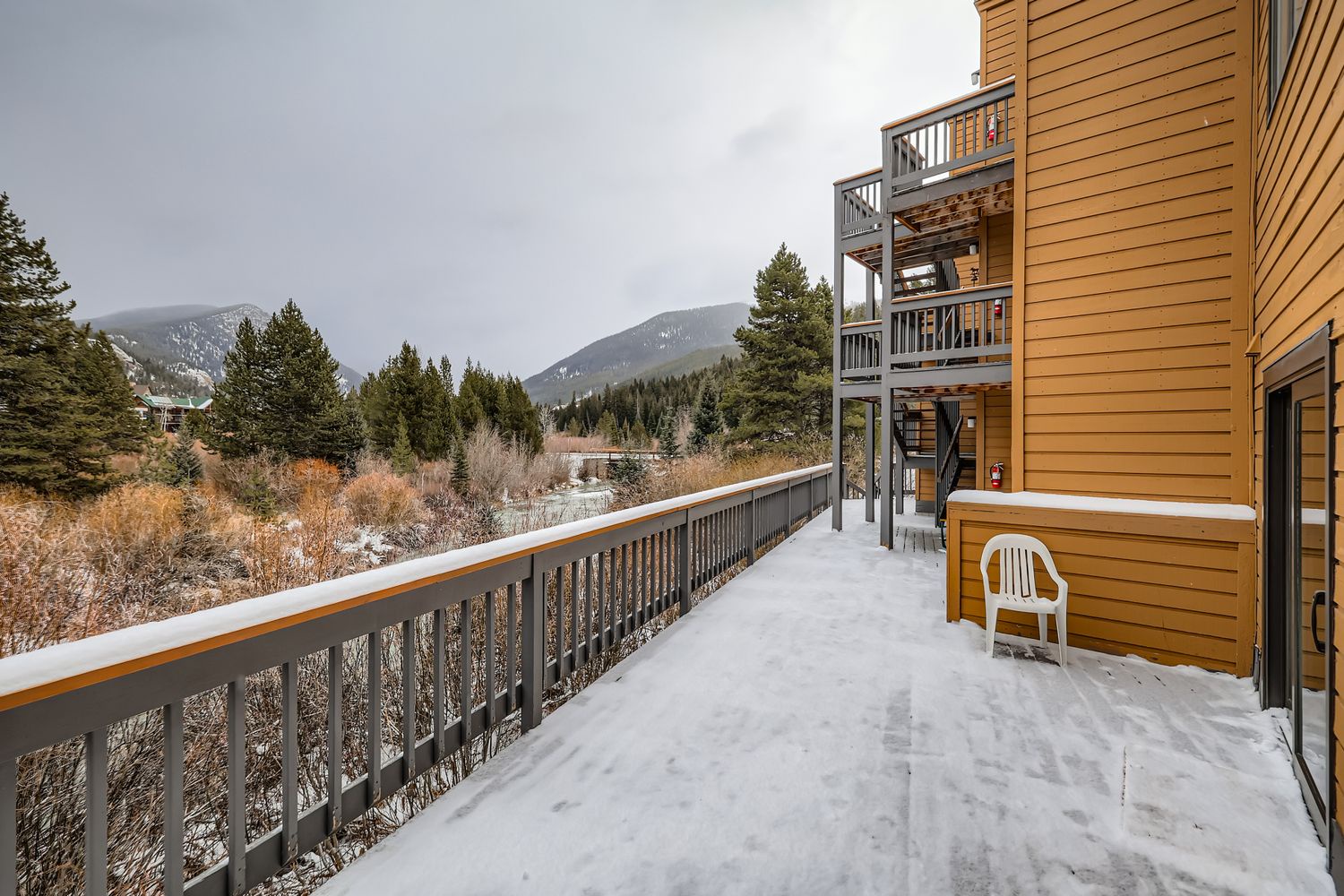 Step onto a snow-covered balcony and breathe in the crisp mountain air while taking in the stunning winter landscape that surrounds you.
