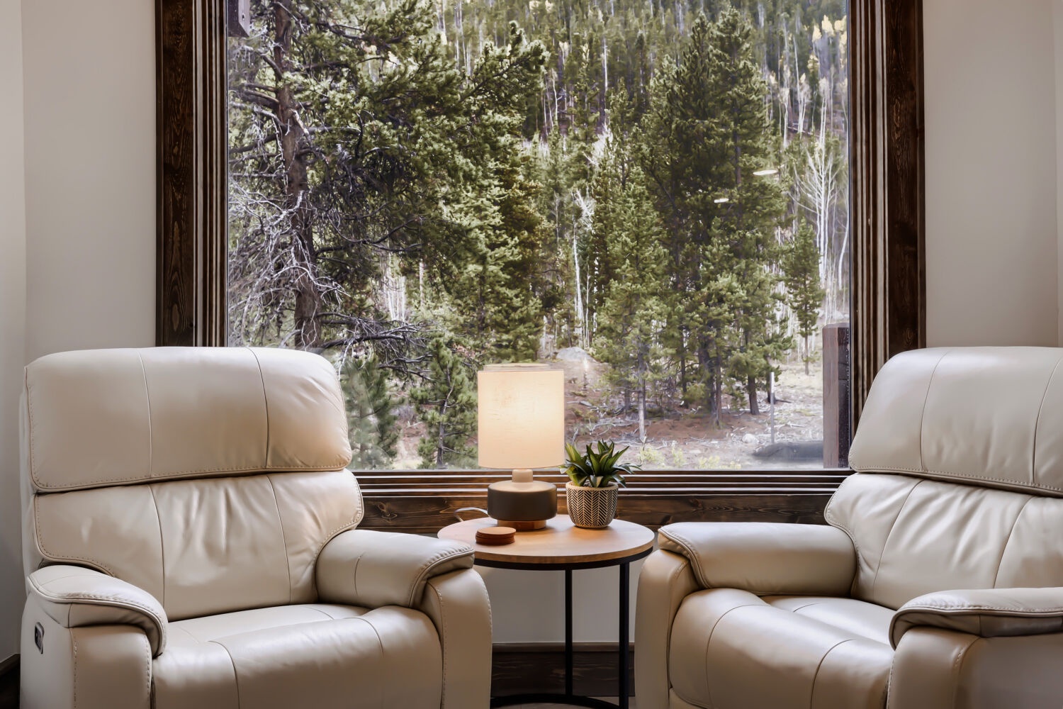 Sink into plush recliners and gaze through the window at towering evergreens just beyond, bringing the peaceful forest right to your retreat.