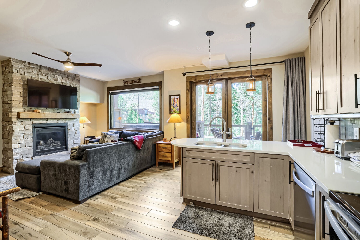 Curl up by the fireplace or whip up a quick meal while natural light floods this open-concept space. Your living area and kitchen flow seamlessly together, with doors opening to the outdoors.