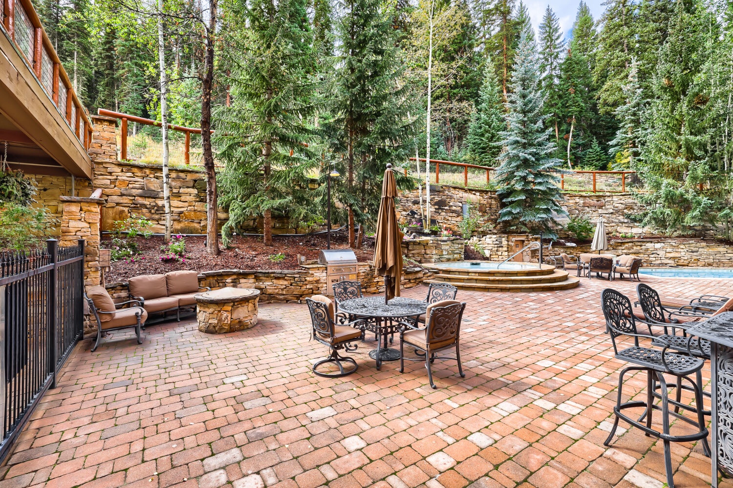 Step onto your private brick patio surrounded by towering pines and aspens. Gather around the stone fire pit, soak in the hot tub, and unwind in your own forest retreat.