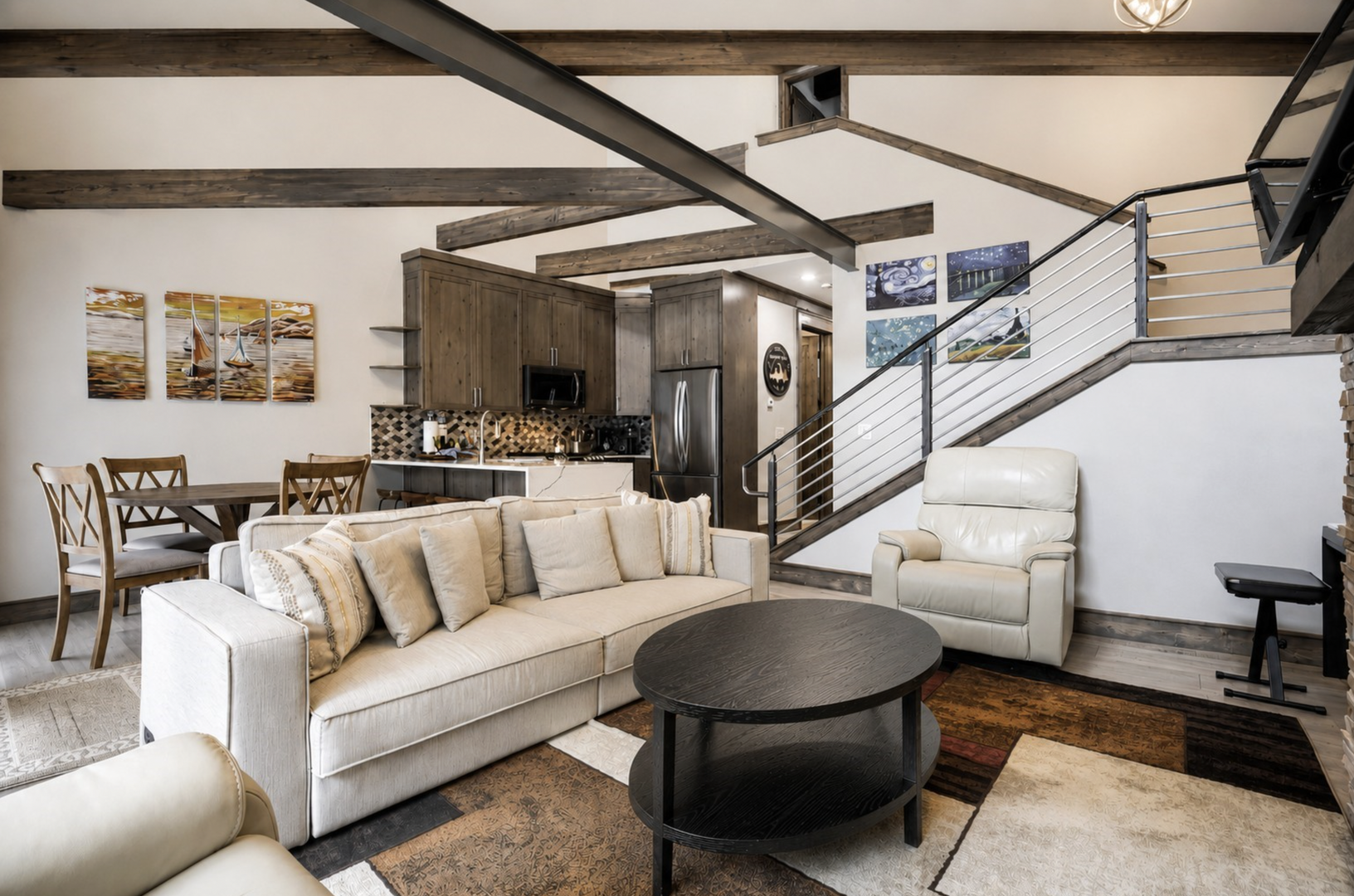 Unwind in your open-concept living space with exposed beams, modern kitchen, and inviting seating—perfect for gathering after a day of adventure.