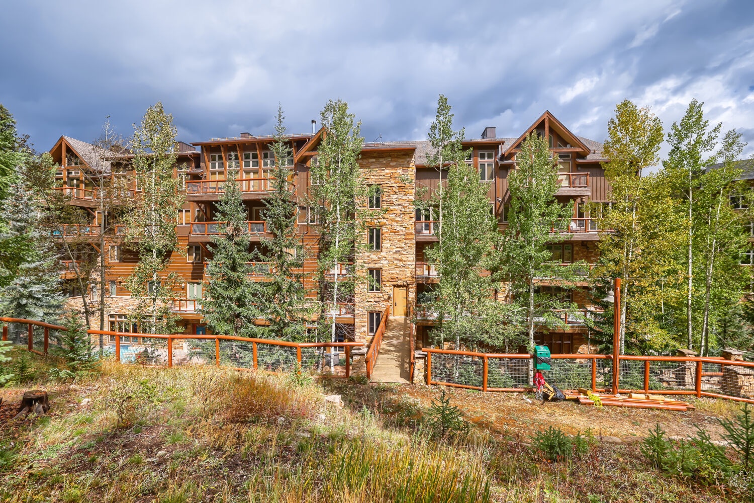 A beautifully crafted mountain lodge nestled among aspens and evergreens, offering authentic alpine architecture and a peaceful natural setting for your retreat.