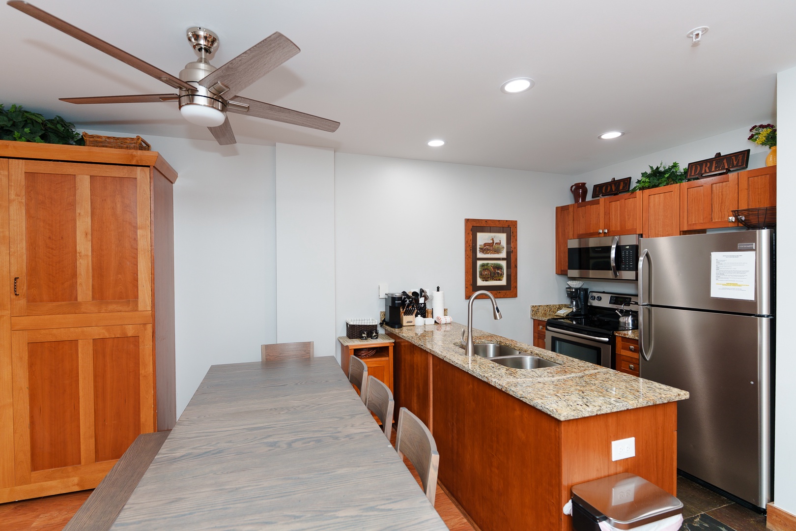 Your fully equipped kitchen features granite countertops, stainless steel appliances, and a spacious dining area - perfect for preparing and enjoying meals during your stay.