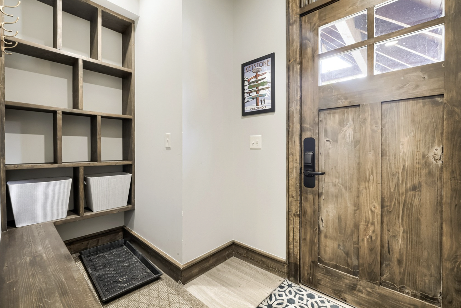 Step into your welcoming entryway with thoughtful touches like built-in storage cubbies, a boot tray, and rustic wood door that sets the tone for your cozy mountain retreat.