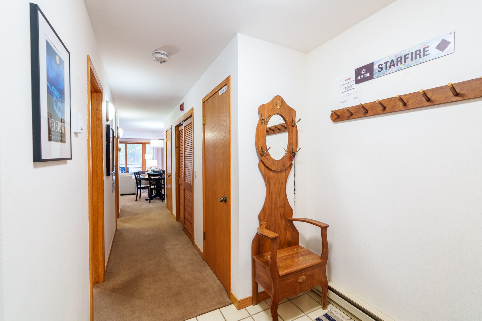 Step into your welcoming hallway featuring charming nautical touches and warm wood accents that guide you to cozy spaces ahead.