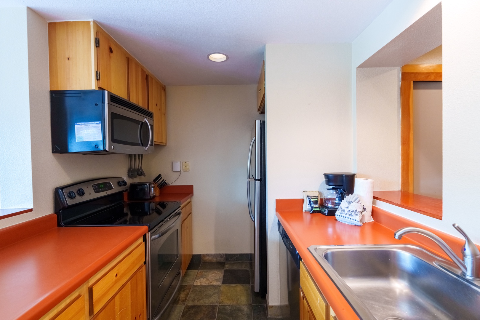 Your fully equipped kitchen puts home-cooked meals at your fingertips, with modern appliances and vibrant countertops ready for whatever culinary adventures you're craving.