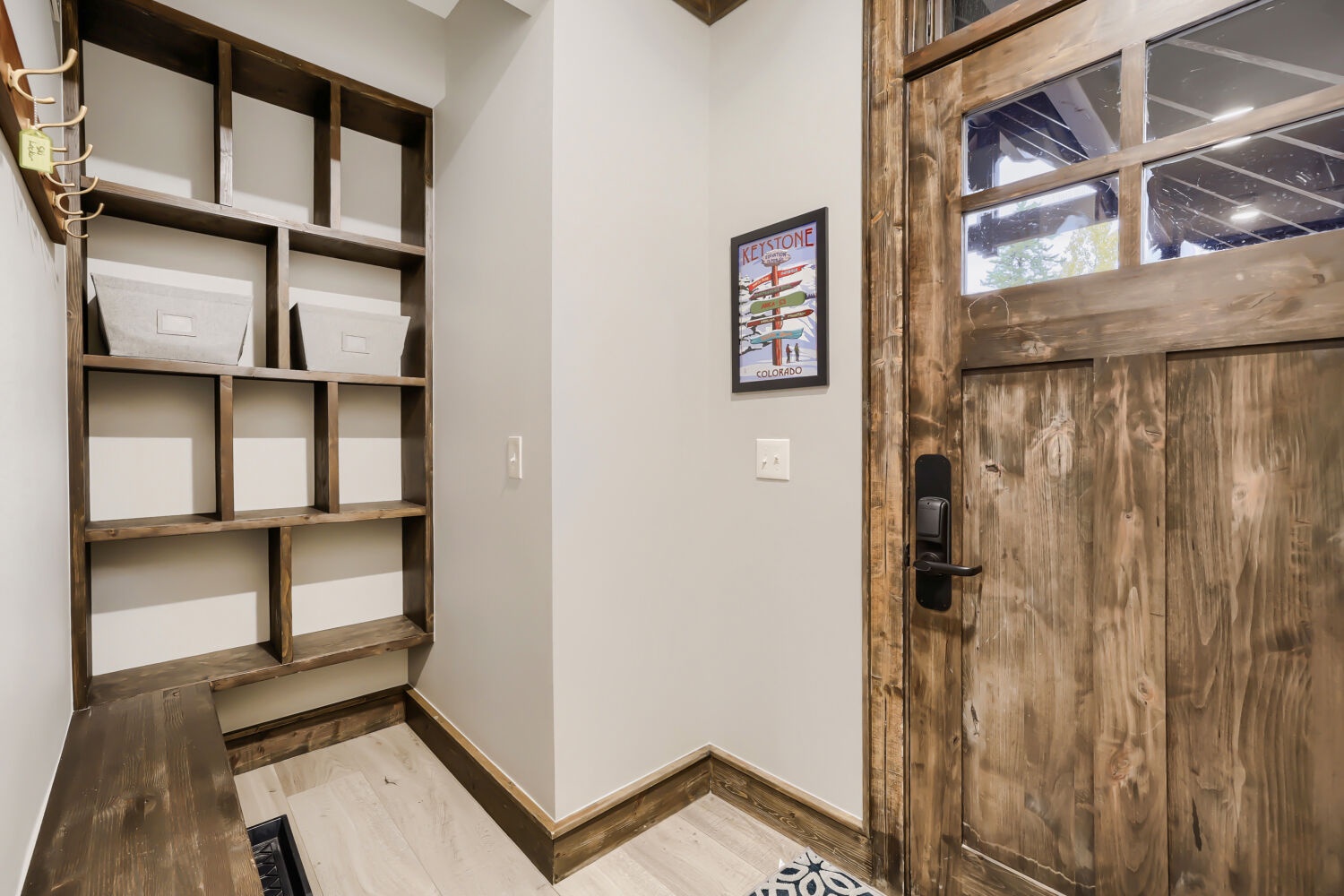Step into your mountain retreat with a welcoming entryway featuring rustic wood accents and smart storage cubbies to keep your gear organized during your stay.