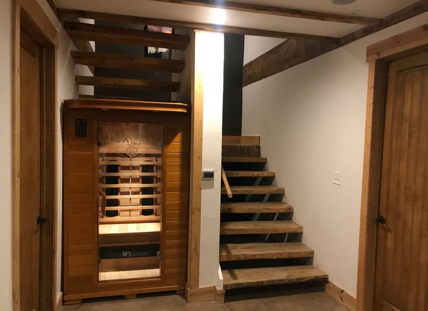 Step into relaxation with your own private infrared sauna, perfectly tucked beneath rustic wooden beams that add warmth and character to your retreat space.