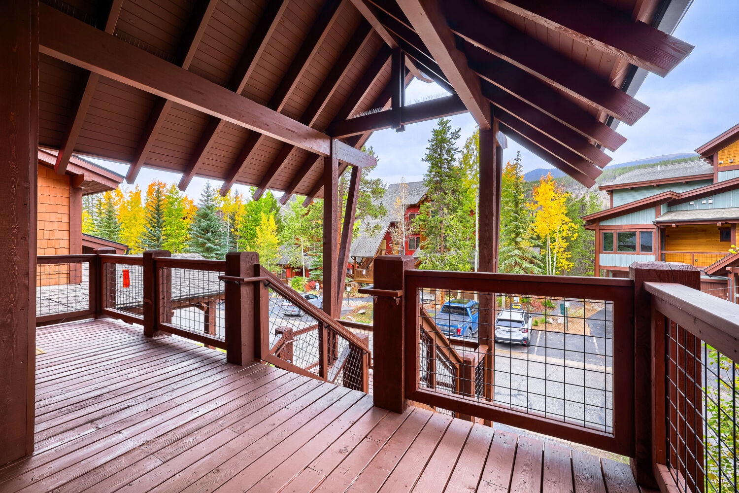 Step onto your private balcony and take in the vibrant autumn colors framing mountain views. The crafted wood beams overhead and spacious deck invite you to relax in the crisp alpine air.