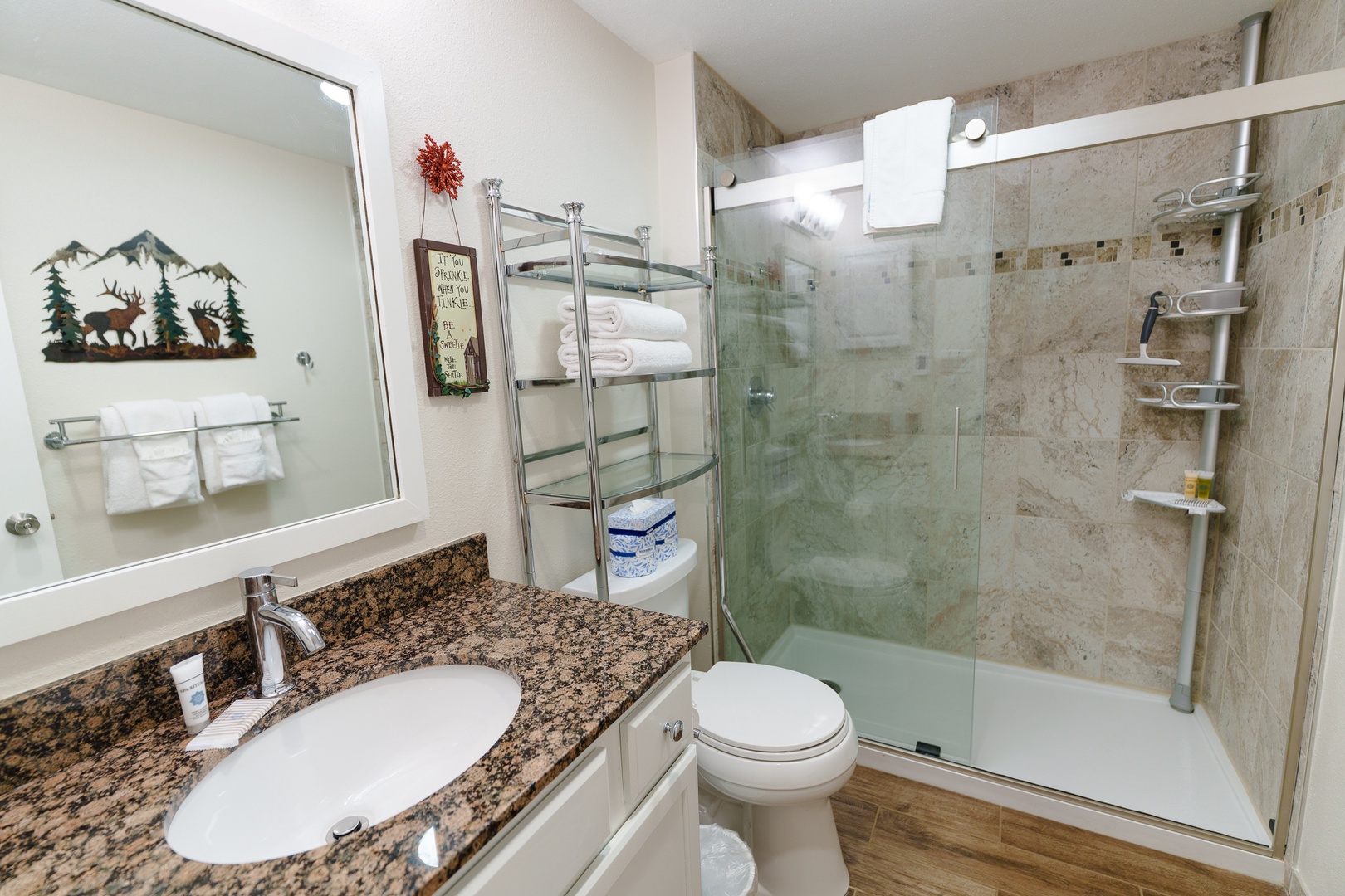 Your private bathroom features a sleek glass shower, granite countertops, and thoughtful amenities to refresh after your adventures.