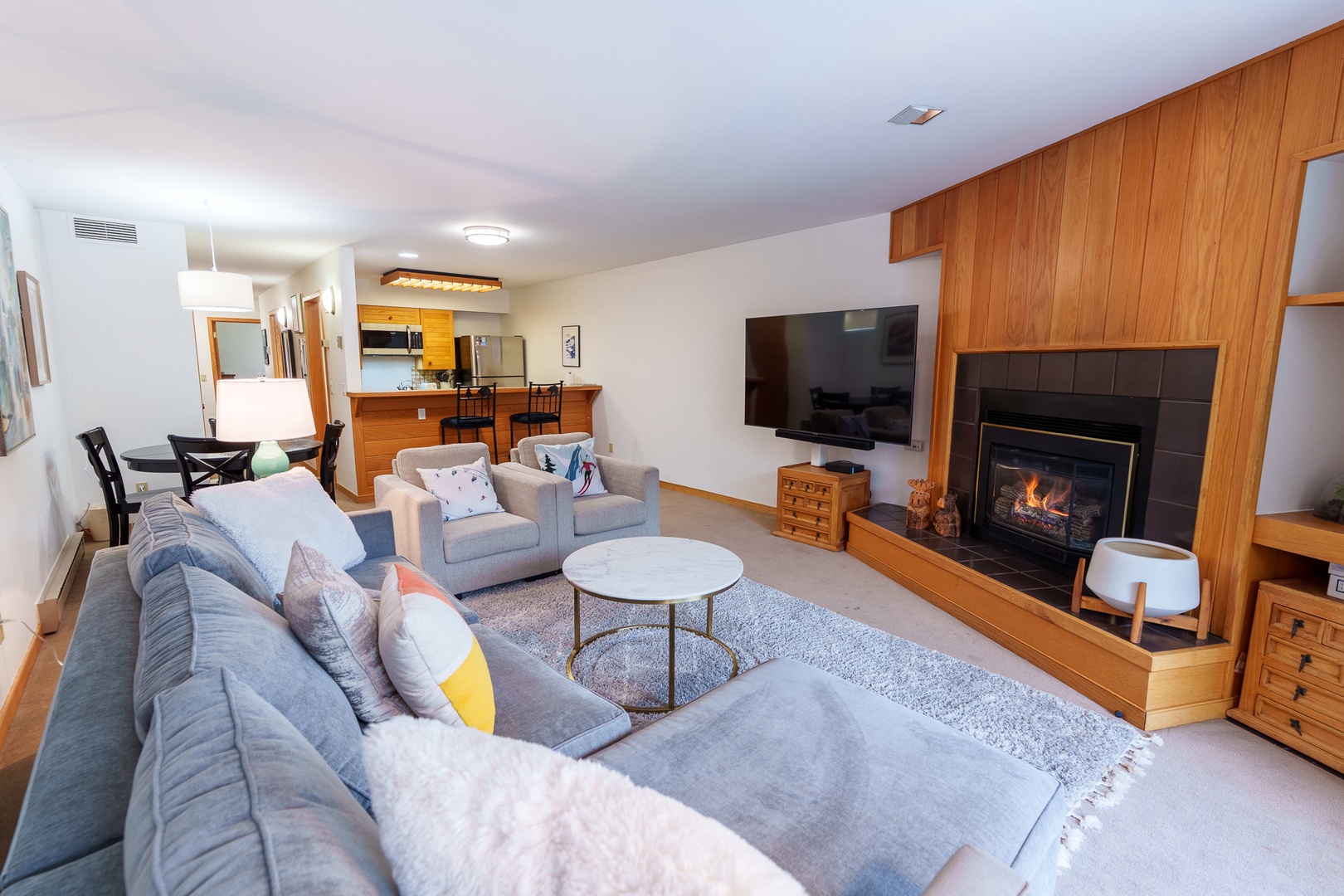 Sink into plush sofas by your cozy fireplace while you unwind with your favorite show in this beautifully appointed living space.