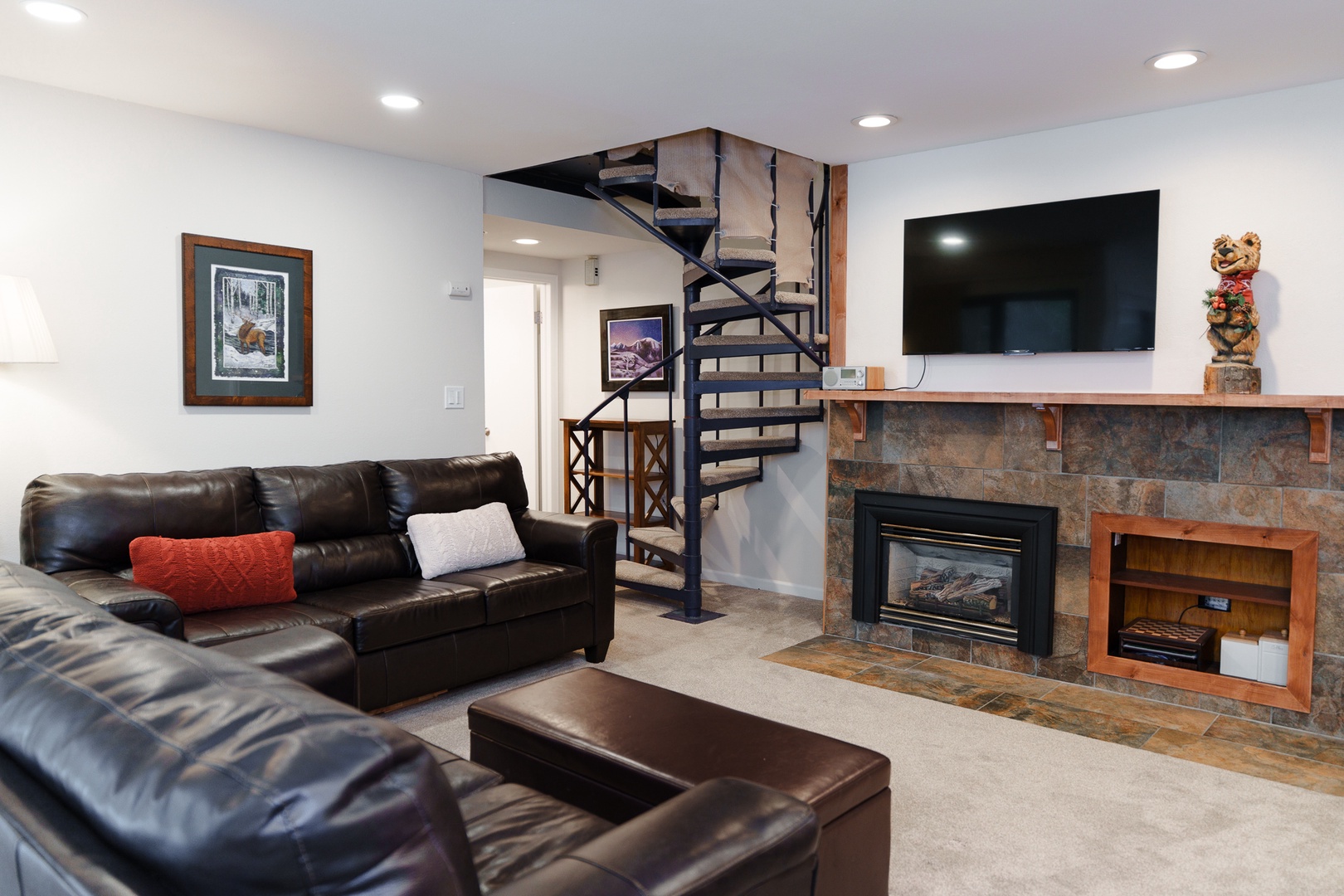 Relax in your spacious living area with plush leather seating, cozy fireplace, and large TV - perfect for unwinding after your mountain adventures.
