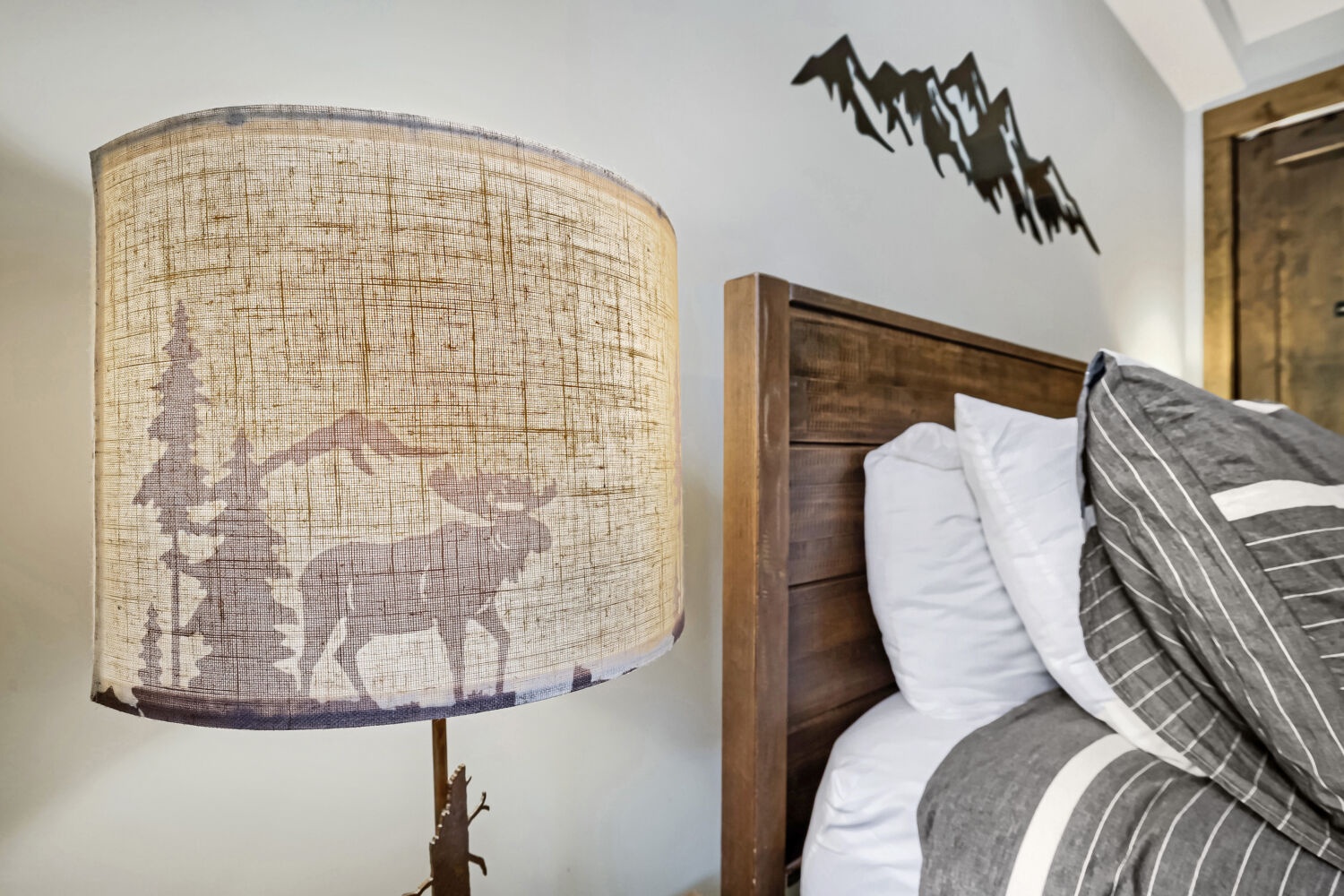 Sink into plush pillows and crisp linens with rustic mountain charm. Your cozy retreat features warm wood details and nature-inspired décor for restful nights.