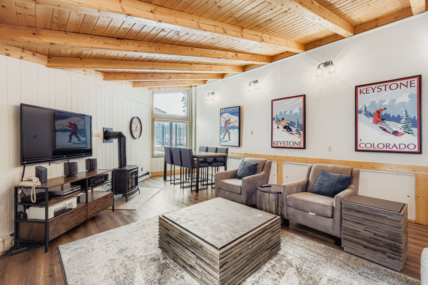 Relax in your cozy guest club house with exposed wood beam ceilings, comfortable seating, and entertainment center - perfect for unwinding after mountain adventures.